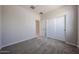 Well-lit bedroom with carpet, neutral walls, closet with sliding doors, and ample natural light at 35295 W La Paz St, Maricopa, AZ 85138