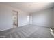 A carpeted bedroom features a window that lets in natural light at 35295 W La Paz St, Maricopa, AZ 85138
