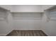 A spacious walk-in closet features neutral carpeting and ample shelving for storage and organization at 35295 W La Paz St, Maricopa, AZ 85138
