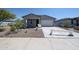 Charming single-story home featuring a well-maintained yard and attached two-car garage at 35295 W La Paz St, Maricopa, AZ 85138