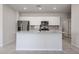 Bright kitchen features stainless steel appliances, granite countertops and gray tile backsplash at 35295 W La Paz St, Maricopa, AZ 85138
