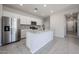 Bright kitchen features stainless steel appliances, granite countertops and gray tile backsplash at 35295 W La Paz St, Maricopa, AZ 85138