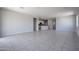 Open-concept living room with tile floors, recessed lighting, and seamless transition to the kitchen at 35295 W La Paz St, Maricopa, AZ 85138