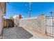 A brick paver patio enclosed by a block wall and a wooden fence at 3601 N 12Th St, Phoenix, AZ 85014