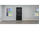 A view of the front door from the inside with wood-style tile flooring and neutral walls at 3601 N 12Th St, Phoenix, AZ 85014