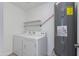 A practical laundry room with a washer, dryer, shelving, and water heater at 3601 N 12Th St, Phoenix, AZ 85014