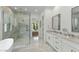 Well-lit primary bathroom featuring double sink vanity, marble countertop, and glass shower at 3808 E Fairmount Ave, Phoenix, AZ 85018