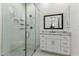 Contemporary bathroom featuring a glass-enclosed shower, subway tiles, and a sleek white vanity with marble countertop at 3808 E Fairmount Ave, Phoenix, AZ 85018