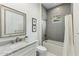 Stylish bathroom featuring a shower-tub combo, gray subway tile, and a modern vanity with a marble countertop at 3808 E Fairmount Ave, Phoenix, AZ 85018