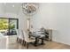 Bright dining room features chandelier, modern furniture, and sliding glass doors to backyard at 3808 E Fairmount Ave, Phoenix, AZ 85018