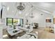 Bright living room featuring vaulted ceilings, modern chandeliers, and seamless indoor/outdoor flow to the pool area at 3808 E Fairmount Ave, Phoenix, AZ 85018