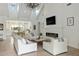 Bright living room featuring vaulted ceiling, fireplace, and open floor plan to kitchen at 3808 E Fairmount Ave, Phoenix, AZ 85018