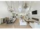 Bright living room with vaulted ceilings, modern chandeliers, a dining area, and a fireplace at 3808 E Fairmount Ave, Phoenix, AZ 85018