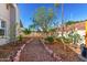 Backyard features stone-lined pathways, gravel landscaping, and raised garden beds at 3923 S Dorsey Ln, Tempe, AZ 85282