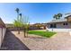 Spacious backyard features gravel landscaping, a small grass patch, and privacy fencing at 3923 S Dorsey Ln, Tempe, AZ 85282