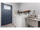 Laundry room with utility sink, shelving, and a modern washer and dryer set at 3923 S Dorsey Ln, Tempe, AZ 85282