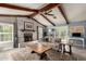 Cozy living room with exposed beam ceiling, fireplace, neutral color palette, and natural light at 3923 S Dorsey Ln, Tempe, AZ 85282