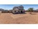 Expansive backyard with low-maintenance gravel landscaping, covered patio, and view of neighboring houses at 3932 N 306Th Ln, Buckeye, AZ 85396