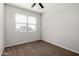 This carpeted bedroom features a window with exterior view, and overhead lighting at 3932 N 306Th Ln, Buckeye, AZ 85396