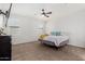 Bright main bedroom with carpet, a ceiling fan, and two windows providing natural light at 3932 N 306Th Ln, Buckeye, AZ 85396