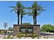 Community sign with palm trees and decorative stone, welcoming residents to Tartesso at 3932 N 306Th Ln, Buckeye, AZ 85396