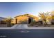 Charming single-story home featuring a well-maintained front yard and a two-car garage at 3982 E Sidesaddle Rd, San Tan Valley, AZ 85140