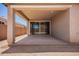 The back patio has concrete flooring and neutral colored columns and walls at 40546 W Michaels Dr, Maricopa, AZ 85138