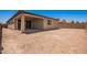 The backyard features a covered patio, desert landscaping and a block wall at 40546 W Michaels Dr, Maricopa, AZ 85138