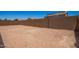 The backyard of this home has a block wall and desert landscaping at 40546 W Michaels Dr, Maricopa, AZ 85138