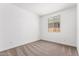 This bedroom has neutral carpet and a window letting in natural light at 40546 W Michaels Dr, Maricopa, AZ 85138