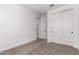 This bedroom has neutral carpet, a window, and a closet with sliding doors at 40546 W Michaels Dr, Maricopa, AZ 85138