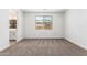 Neutral bedroom with a large window offering neighborhood views and neutral carpet at 40546 W Michaels Dr, Maricopa, AZ 85138