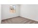 Cozy bedroom with neutral carpet, natural light, and a view to the outdoors at 40546 W Michaels Dr, Maricopa, AZ 85138