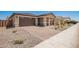 This home features a brick driveway, desert landscaping and a two car garage at 40546 W Michaels Dr, Maricopa, AZ 85138