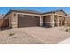 Attached two-car garage and brick-paved driveway complement this attractive single-Gathering home at 40546 W Michaels Dr, Maricopa, AZ 85138
