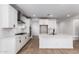 Bright kitchen with white cabinets, subway tile backsplash and stainless steel appliances at 40546 W Michaels Dr, Maricopa, AZ 85138