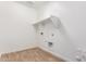 This laundry room features tile flooring and hookups for a washer and dryer at 40546 W Michaels Dr, Maricopa, AZ 85138