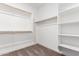 Walk-in closet featuring custom shelving and rod for clothing storage at 40546 W Michaels Dr, Maricopa, AZ 85138