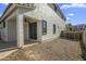 View of the home's backyard with a gravel area, covered patio, and access to the indoors at 4132 E Santa Fe Ln, Gilbert, AZ 85297