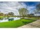 Scenic pond with walking path, vibrant greenery, and blue skies at 4132 E Santa Fe Ln, Gilbert, AZ 85297