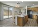 Bright kitchen with island seating, modern cabinetry, and sliding glass doors to the outdoor space at 4132 E Santa Fe Ln, Gilbert, AZ 85297