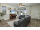 Inviting living room with a comfortable leather couch, a piano, and plenty of natural light at 4132 E Santa Fe Ln, Gilbert, AZ 85297