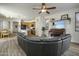 Open-concept layout with a living room flowing into a kitchen featuring wood cabinets and an island with seating at 4132 E Santa Fe Ln, Gilbert, AZ 85297