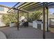 Outdoor kitchen featuring a pergola with a built-in grill, and a brick pizza oven at 4132 E Santa Fe Ln, Gilbert, AZ 85297