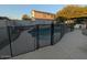 Backyard swimming pool with protective fence and an outdoor kitchen, perfect for entertaining at 4132 E Santa Fe Ln, Gilbert, AZ 85297