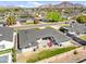 Aerial view of the home featuring a backyard patio with a fire pit, red seating, and mountain views at 4239 E Mitchell Dr, Phoenix, AZ 85018