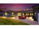 Backyard patio featuring red seating, a fire pit, ambient string lights, and well-manicured landscaping at 4239 E Mitchell Dr, Phoenix, AZ 85018