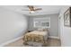 A well-lit bedroom featuring neutral tones, a ceiling fan, and a serene atmosphere for relaxation and rest at 4239 E Mitchell Dr, Phoenix, AZ 85018