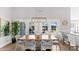 Elegant dining area with a wooden table, modern chairs, and French doors leading to an outdoor patio at 4239 E Mitchell Dr, Phoenix, AZ 85018