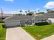 Charming single-story home featuring a well-manicured lawn, a two-car garage, and a cozy front porch at 4239 E Mitchell Dr, Phoenix, AZ 85018